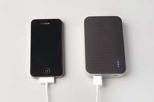 4000mAh Festival phone charger charging an iPhone